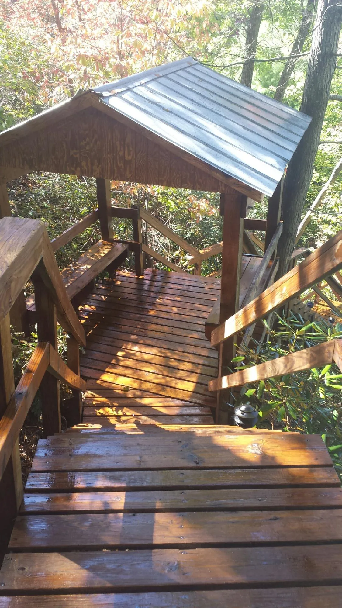 Freshly stained wood walkway and covered shelter with a metal roof in Spokane